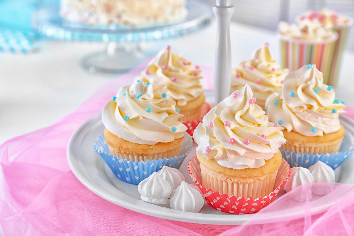 Stand with Delicious Cupcakes on Table